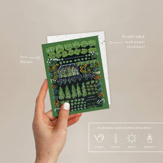 Eco-friendly Garden Greenhouse Card held in hand, showing foil details and plantable seed paper envelope with planting instructions for wildflowers.