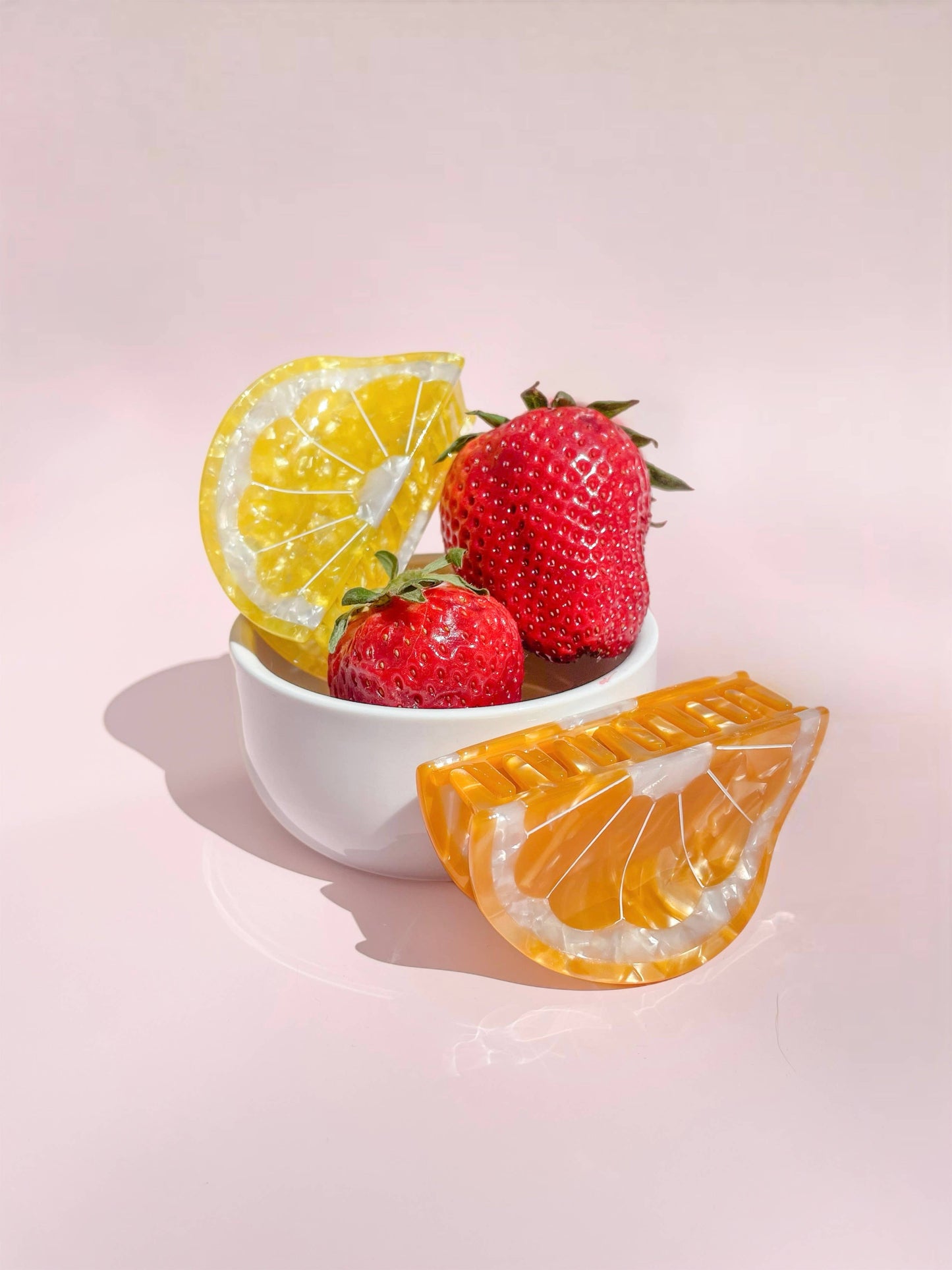 Sunshine Yellow Lemon Claw Hair Clip styled with strawberries in a bowl, showcasing its fruity charm and seasonal accessory appeal.