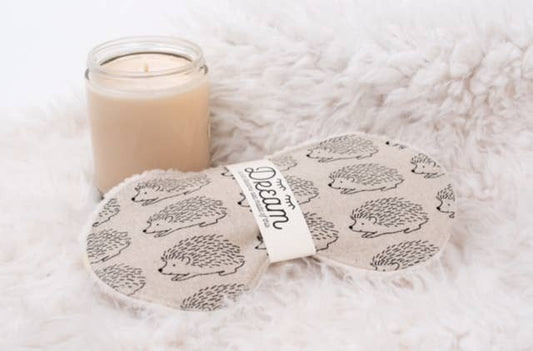 Sweet Dreams Sleep Mask - Linen Hedge Hog pattern shown beside a candle on a fluffy surface, ideal for home relaxation and restful sleep.