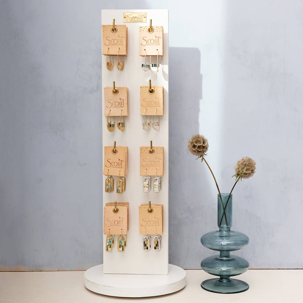 Retail display of Miyuki Crescent Hoop Earrings - Playful Modern Design by Scout Curated Wears. Features multiple color variations on a white stand.