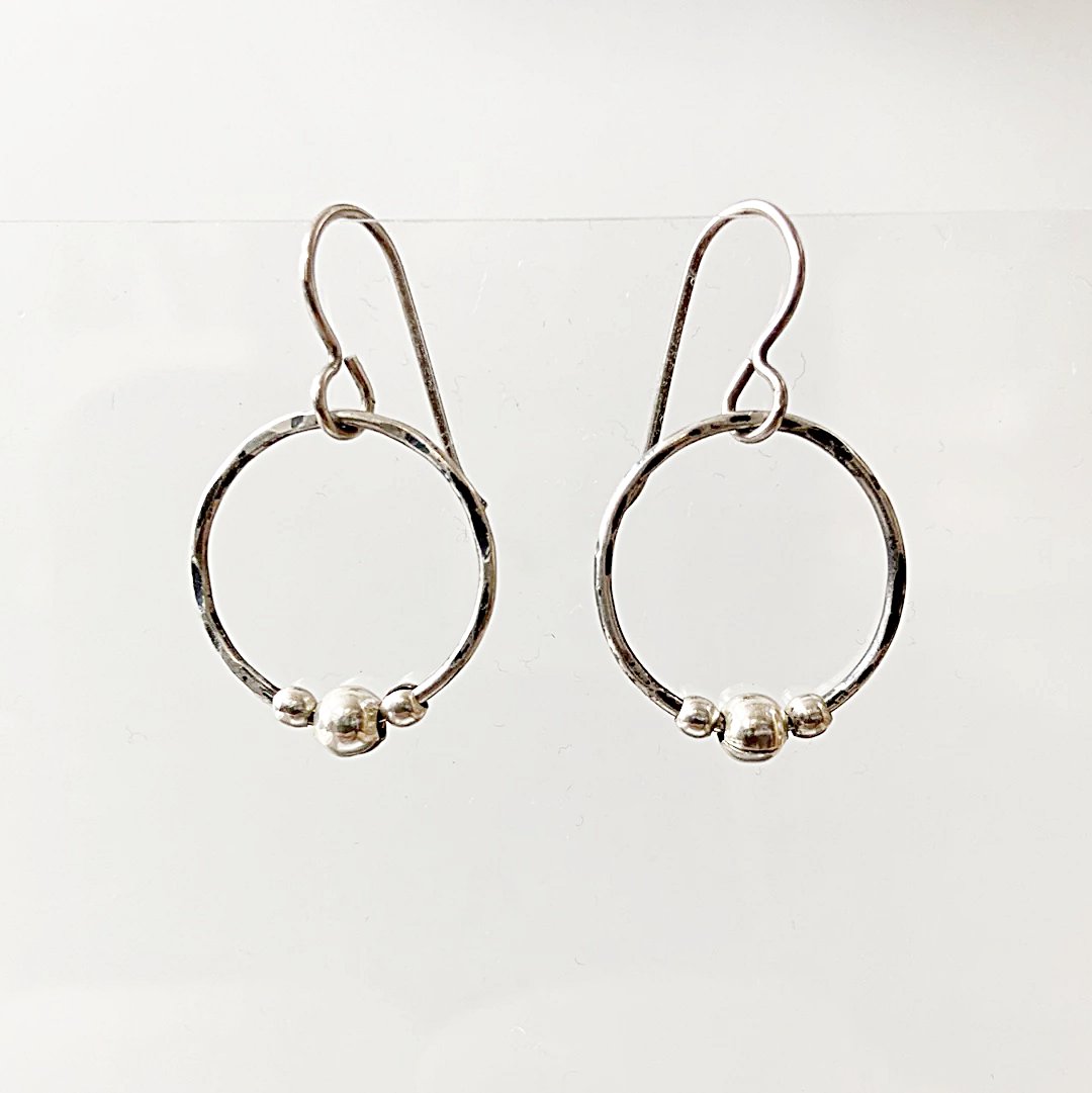 Circle Fidget Earrings from the Circle Fidget Jewelry Set, with hammered silver hoops and three bead accents, shown against a white background.
