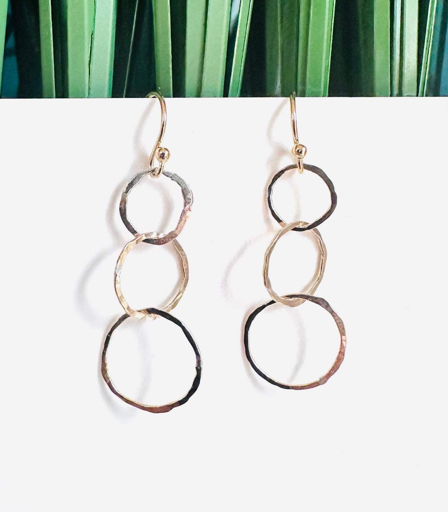 HoopLink Earrings - Silver Gold Hoop Earrings showcasing golden triple hoop dangles with hammered texture, perfect for casual or elegant outfits.