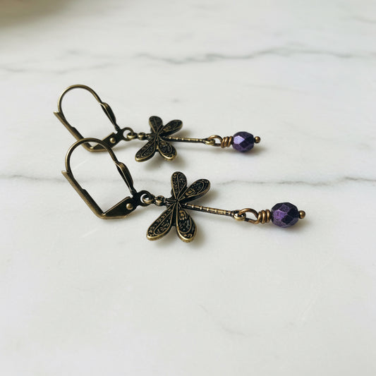 Silver dragonfly earrings with purple bead accents