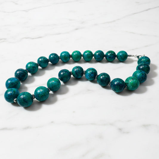 Close-up of blue-green Azurite Chrysocolla beaded necklace with silver accents