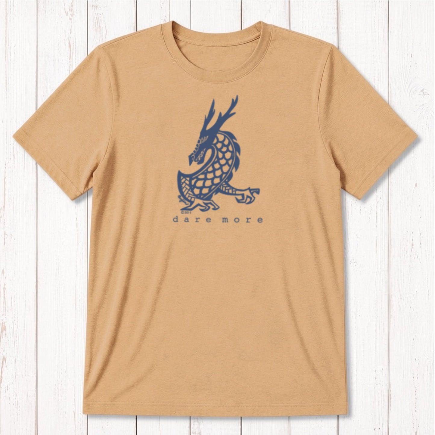 Camel tan men's bamboo and organic cotton t-shirt with bold black dragon graphic and 'Dare More' slogan, fantasy adventure tee for him.