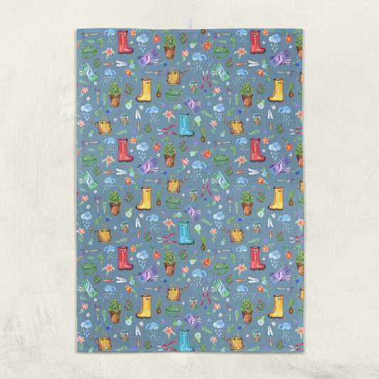 Garden Soul Tea Towel hanging on a wall with gardening pattern