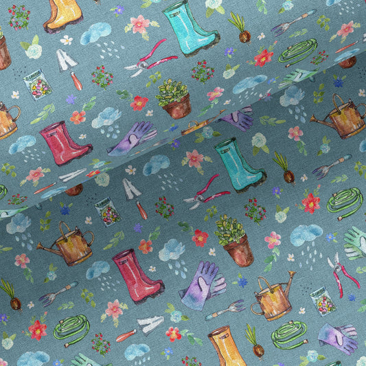 Garden-themed linen-cotton tea towel with gardening tools and plants