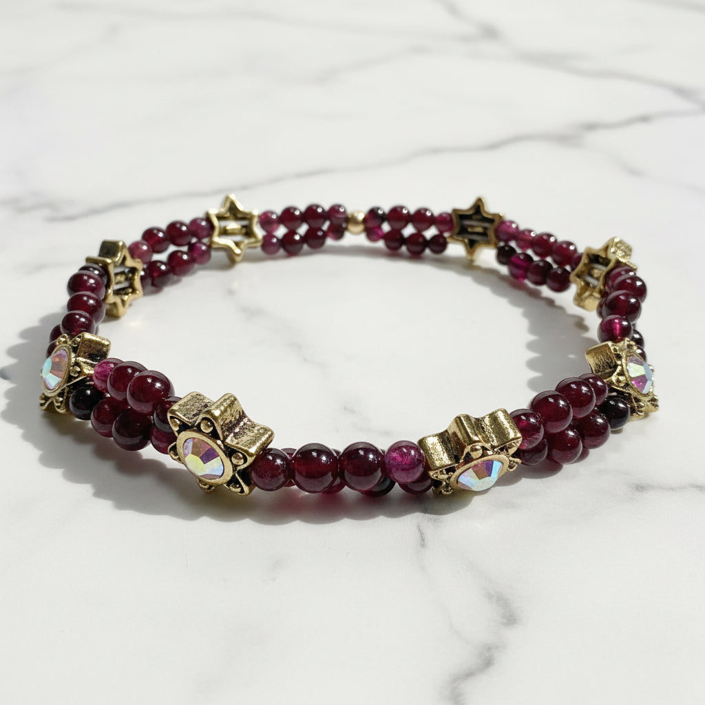 Garnet gemstone stretch bracelet with gold star accents and iridescent beads