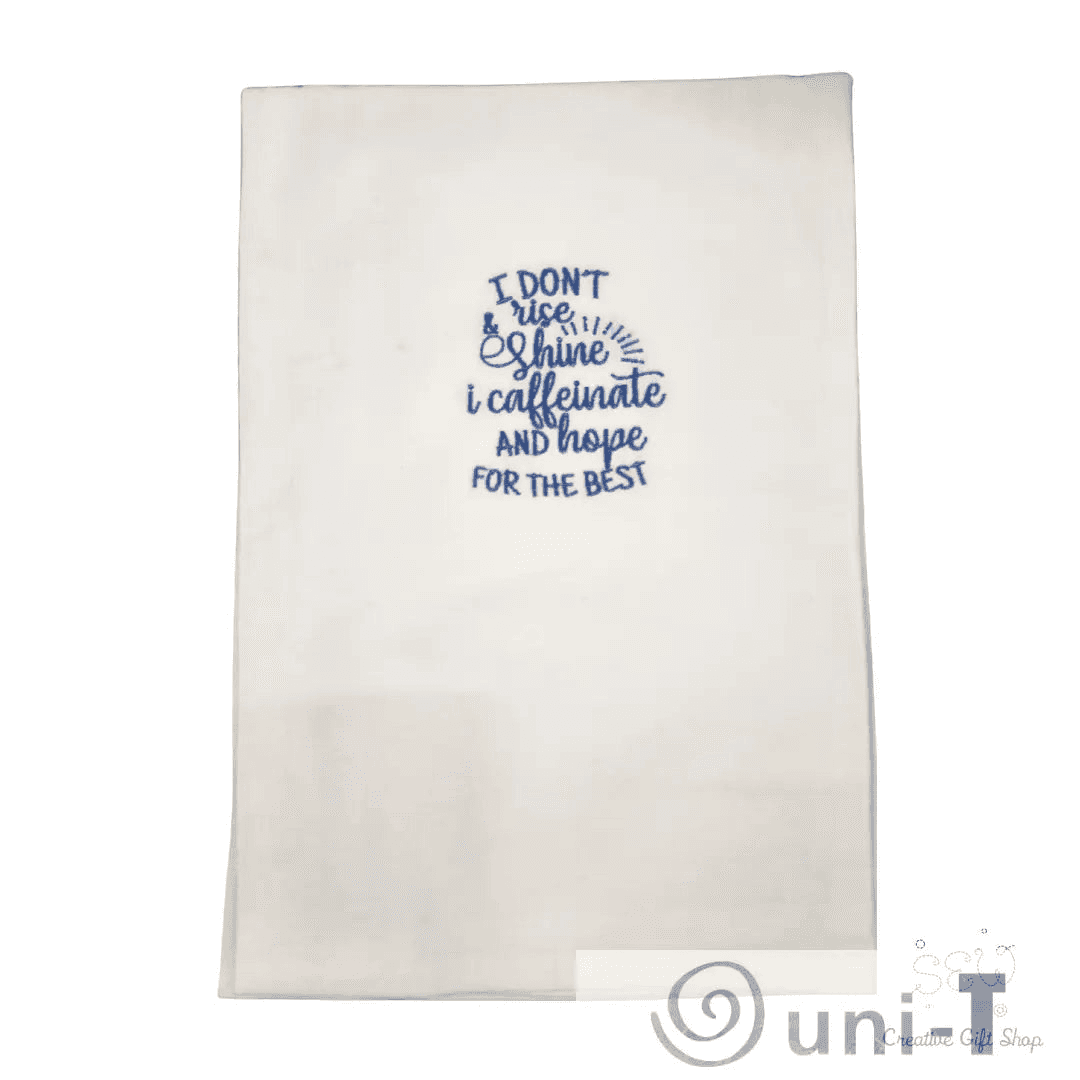 Blue embroidered towel with humorous coffee quote, great for home décor or gifting in the kitchen towels category for coffee fans.