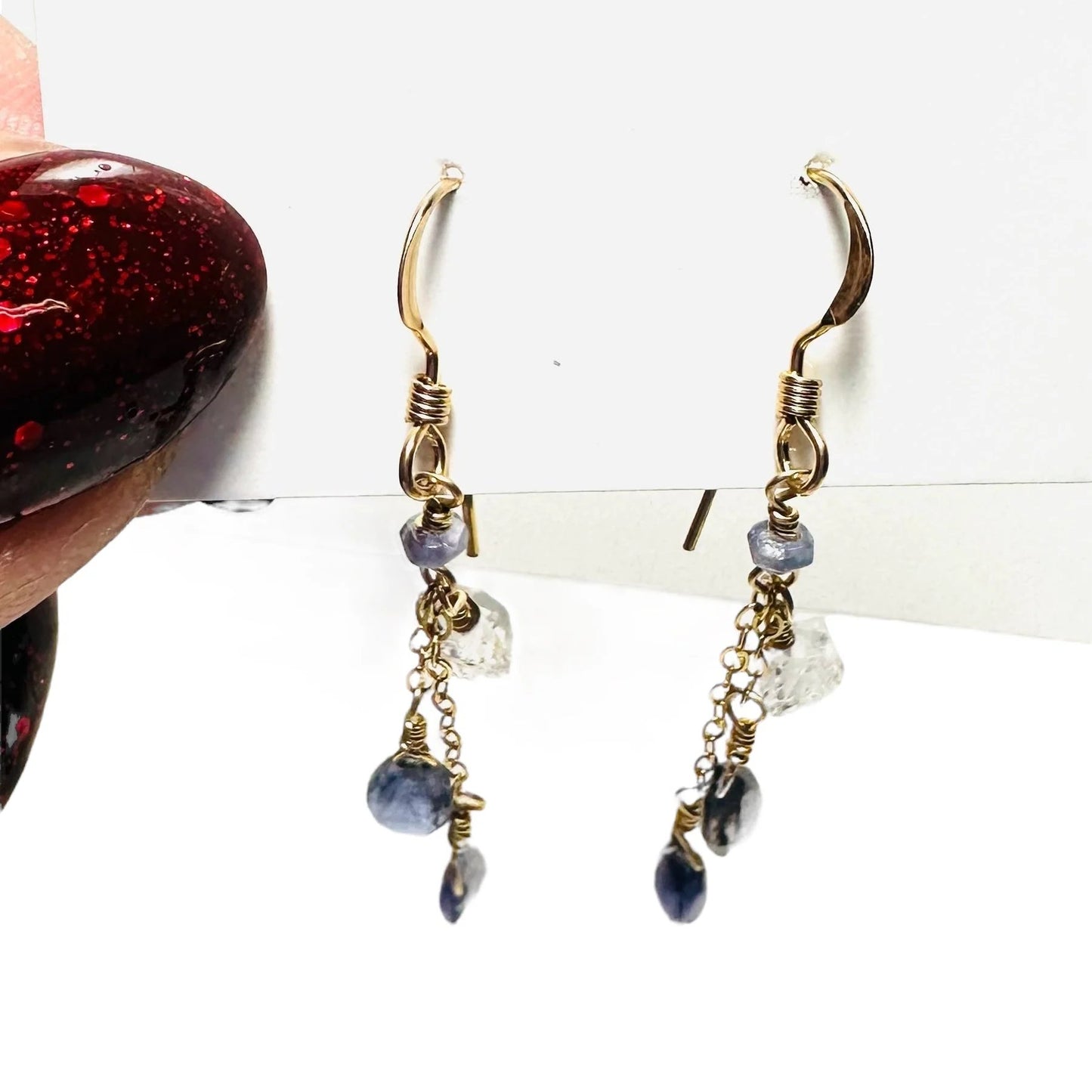 Gold hook earrings with dangling blue and clear gemstones