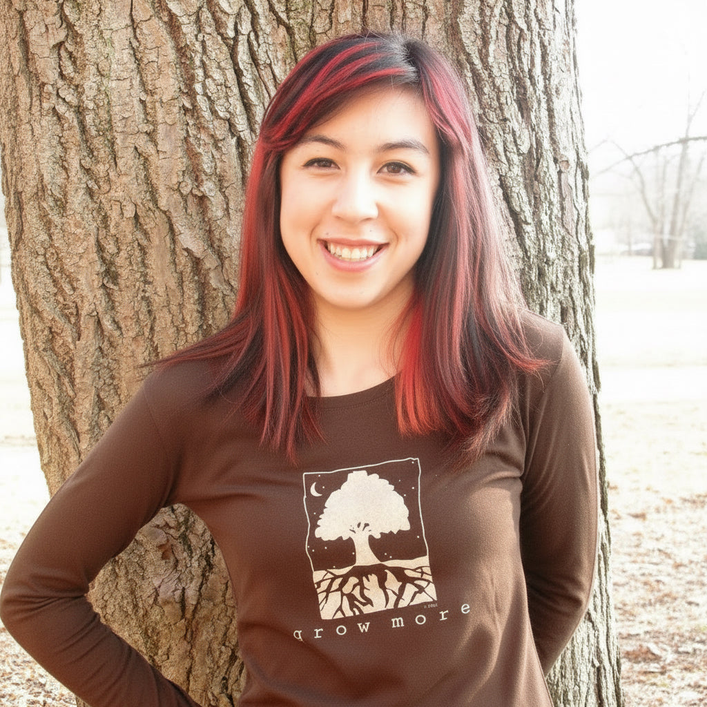 Woman wearing dark brown 'Grow More' tree long sleeve shirt made from bamboo and organic cotton, great for gardening and nature-inspired fashion.