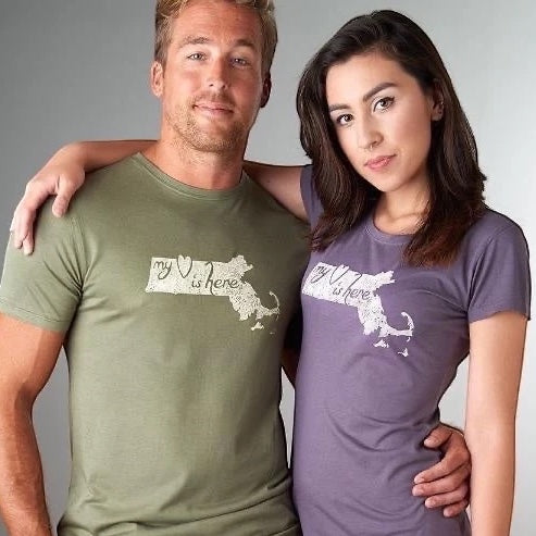 Couple wearing Uni-T bamboo and organic cotton Massachusetts T-Shirts with 'My Heart Is Here' design, perfect for state pride gifting.
