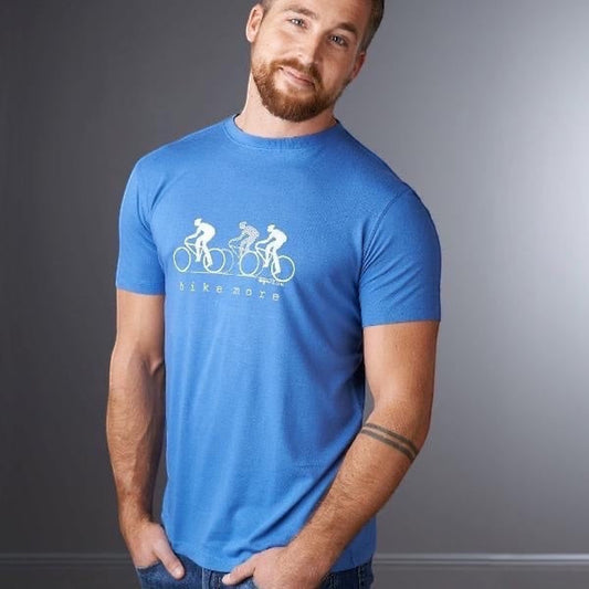 Model wearing Men's Bicycle T-Shirt in Bamboo & Organic Cotton in blue, with 'Bike More' cyclist graphic, ideal for outdoor fitness and cycling.