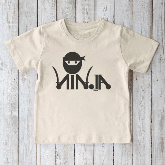 Cream Kids' Ninja Organic Cotton T-Shirt featuring bold black ninja print, sustainable and fun graphic tee for active children by Uni-T.