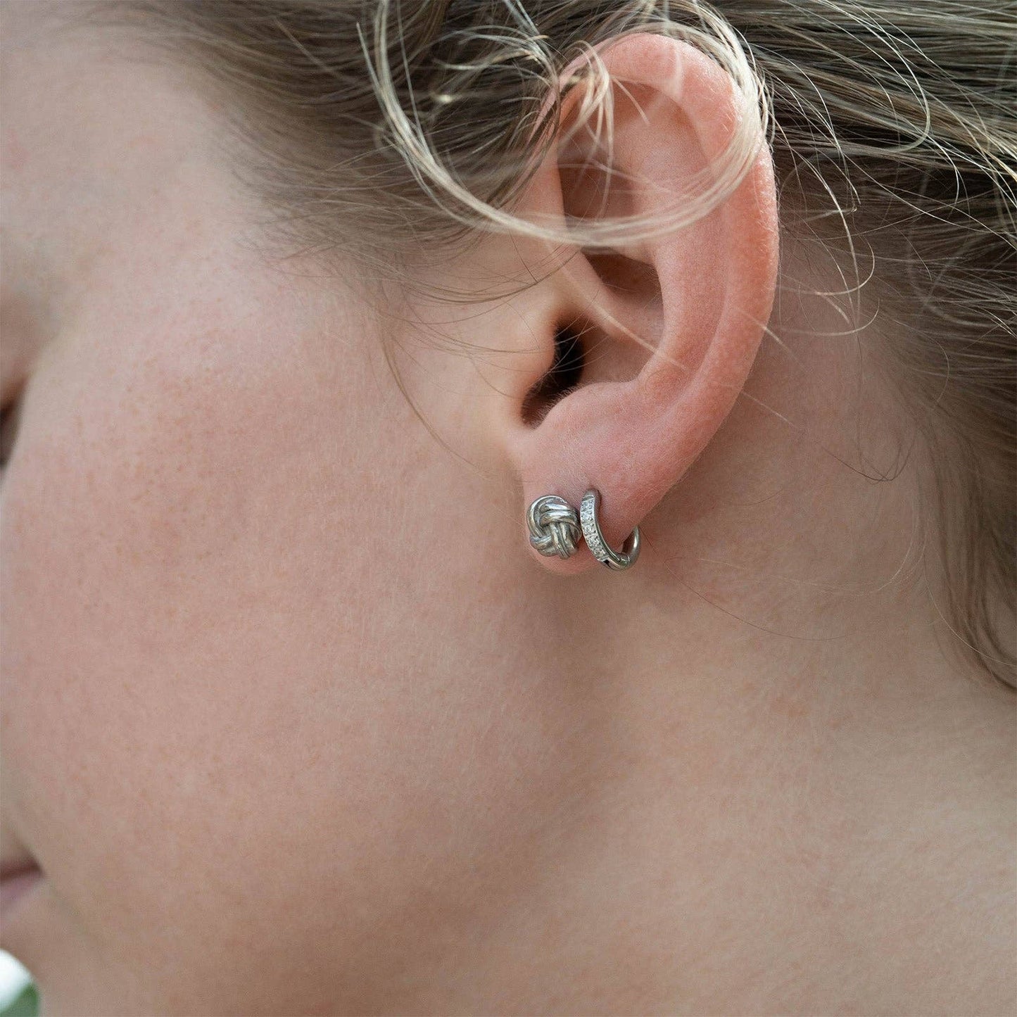 Model wearing Mini Huggie Earrings with diamonds