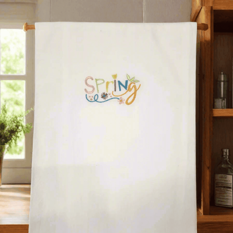Spring Embroidered Towel - Embroidered Kitchen Towel | Durable, hanging in a cozy kitchen setting, perfect for adding a cheerful spring touch.