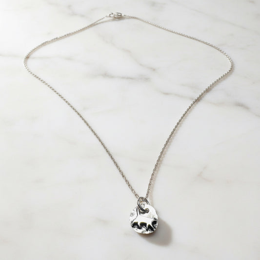 Close-up of Tiny Kitty Necklace silver charm