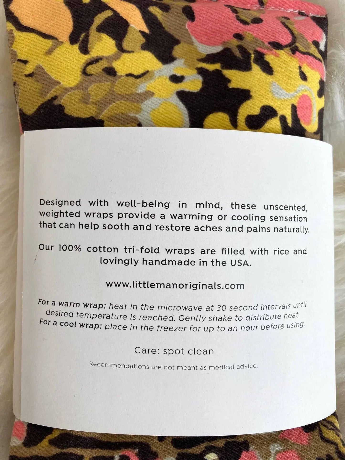 Close-up of therapy wrap label detailing microwave and freezer instructions for warm or cool use, made with 100% cotton and rice.