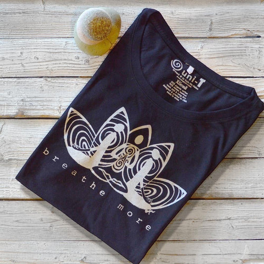 Folded black 'Breathe More' Women's Yoga T-Shirt in Bamboo & Organic Cotton featuring a lotus design, perfect inspirational fitness gift.
