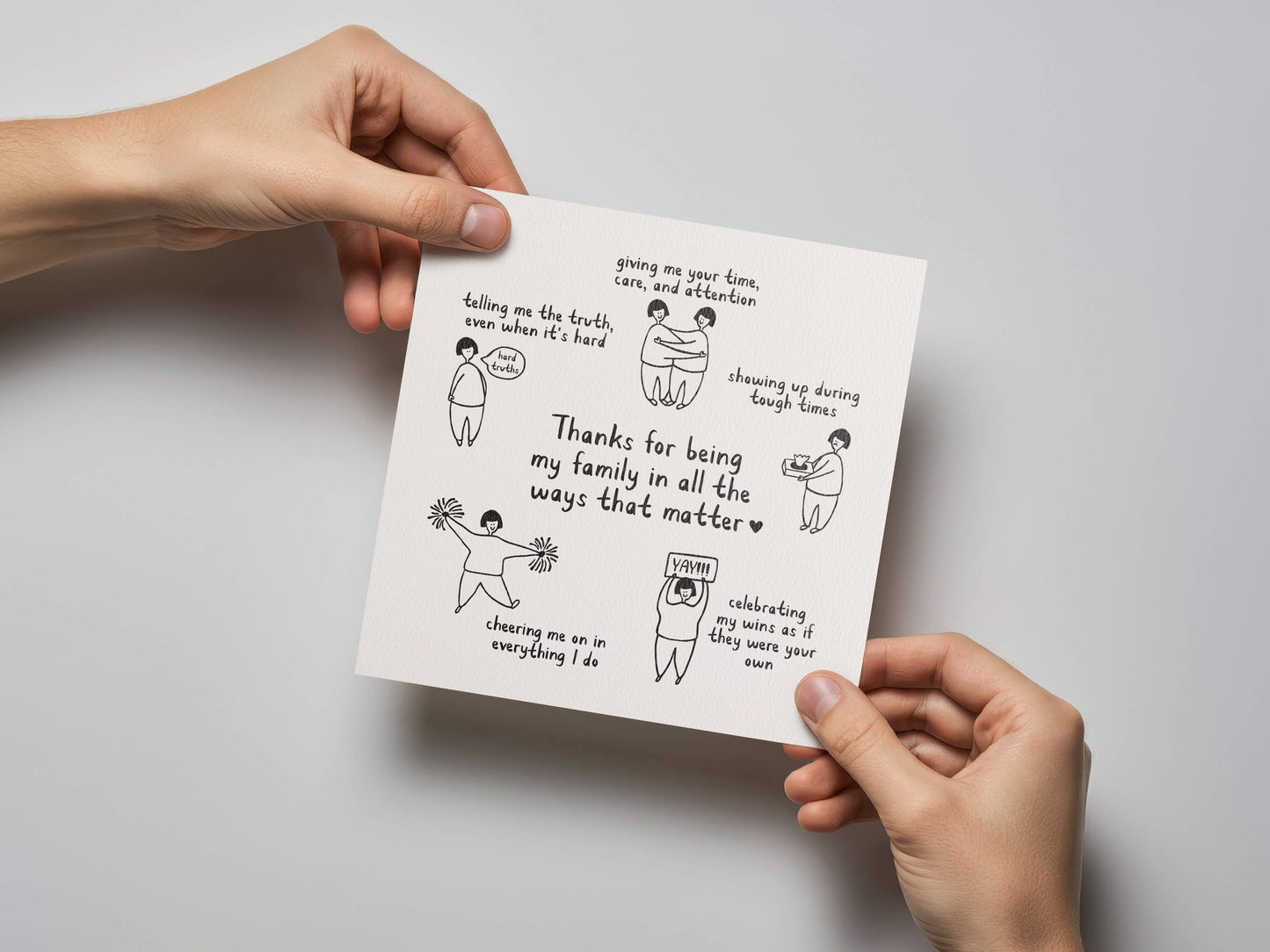 Person holding Thanks For Being My Family Mother's Day Card with illustrations