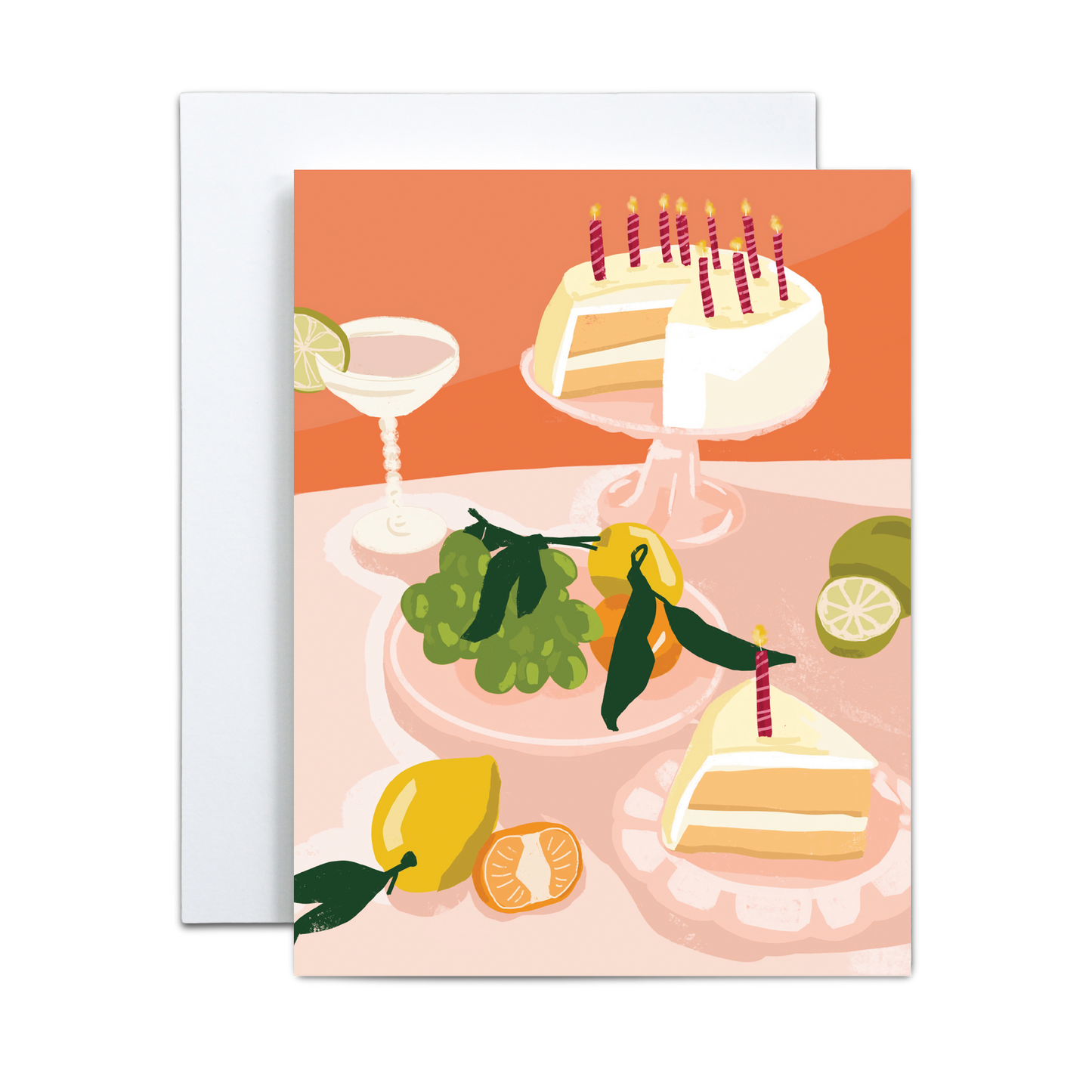 Copper & Print's Birthday Greeting Card Handmade for Celebrations features an illustration of a birthday cake with candles, cake slices, a cocktail glass, green grapes, limes, a tangerine, and a lemon on a peach-toned table.