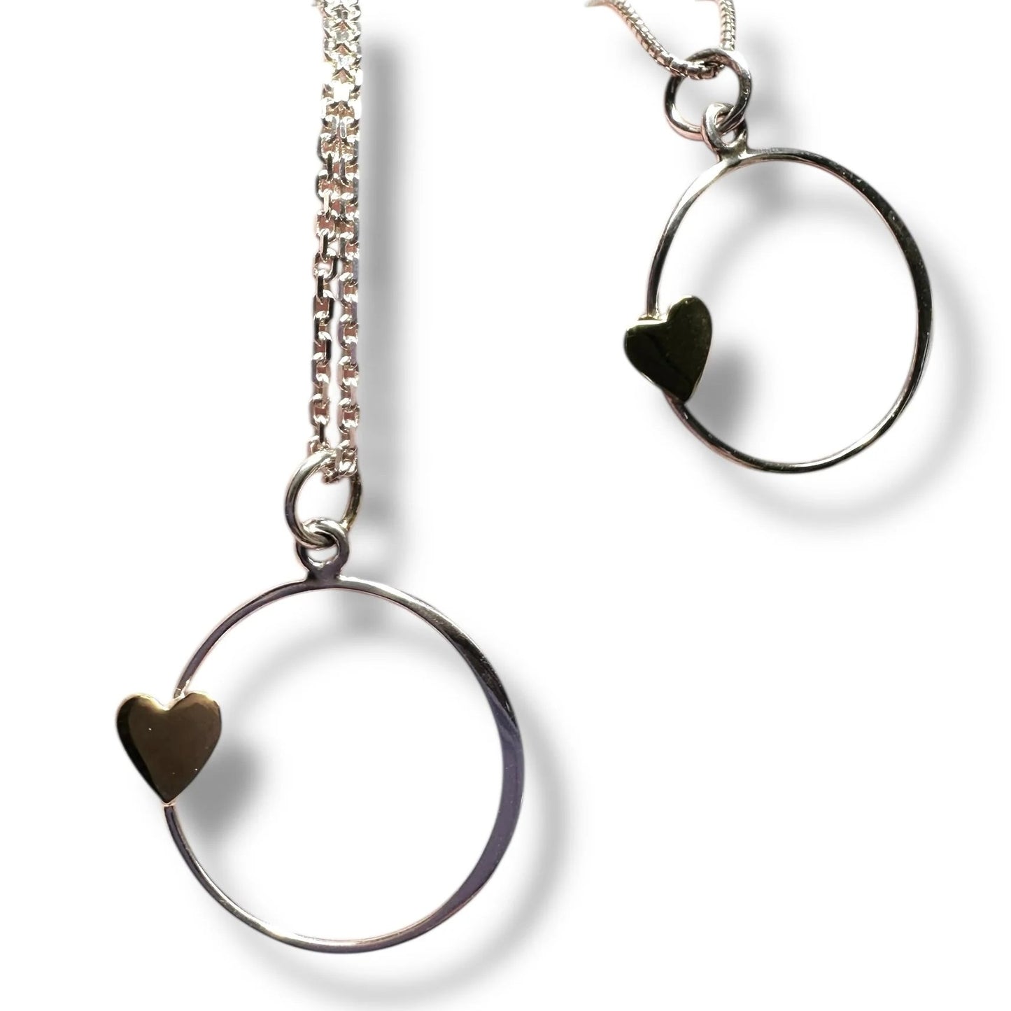 Silver hoop earrings with gold heart detail