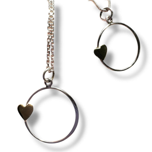 Silver hoop earrings with gold heart detail