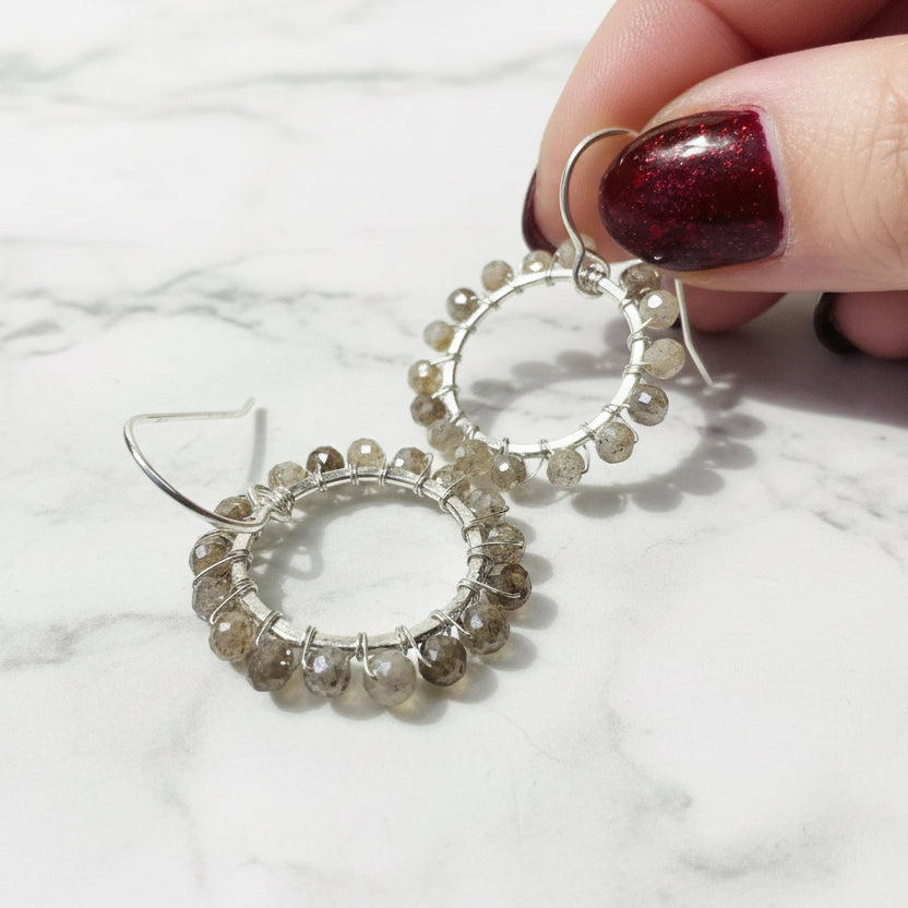 Close-up of beaded hoop moonstone earrings jewelry