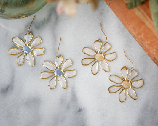 Handcrafted daisy stained glass earrings in soft blue and peach tones, perfect for summer outfits. Unique floral jewelry, shop now.