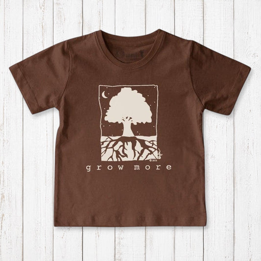 Uni-T kids brown organic cotton t-shirt featuring a white Grow More tree illustration on a rustic wood background.