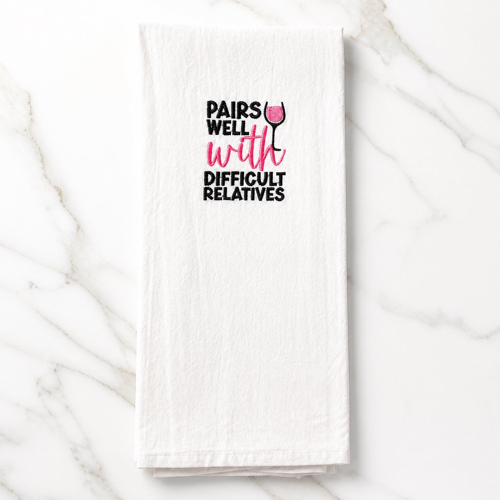 Uni-T white flour sack kitchen towel with black and pink embroidered text Pairs Well With Difficult Relatives