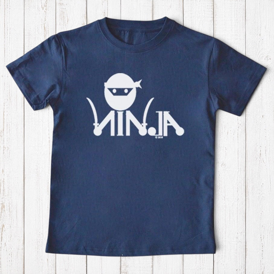 Uni-T navy blue organic cotton kids t-shirt with a white ninja graphic and text on a white wooden background