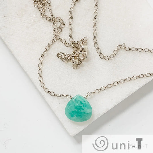 Dainty 18-inch sterling silver necklace with genuine amazonite gemstone pendant from Uni-T, shown coiled on a marble surface.