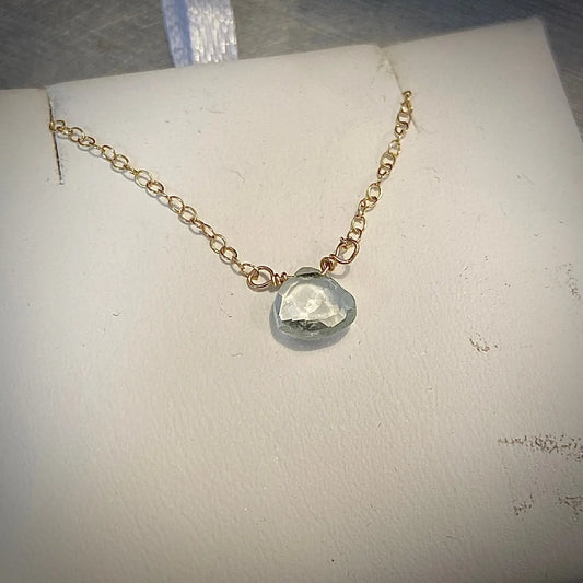 Close-up of Aquamarine Necklace - Gemstone Jewelry|Elegant Design with a heart-shaped aquamarine stone on a fine gold chain. Perfect for everyday elegance.