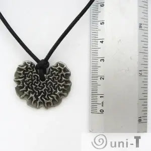 Close-up of Bacillus subtilis Necklace beside ruler for scale, highlighting intricate biofilm-inspired pendant. Scientific jewelry for microbiology lovers.