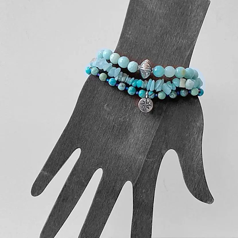 Beaded Bracelet Stack - Beaded Stack Bracelets | 3 Piece Set displayed on a mannequin hand, highlighting the layered design and silver charm details.