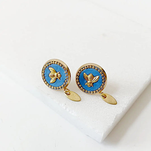 Elegant bee stud earrings in brass with blue crystal and gold bee detail, ideal for all-day wear and unique accessory collections.