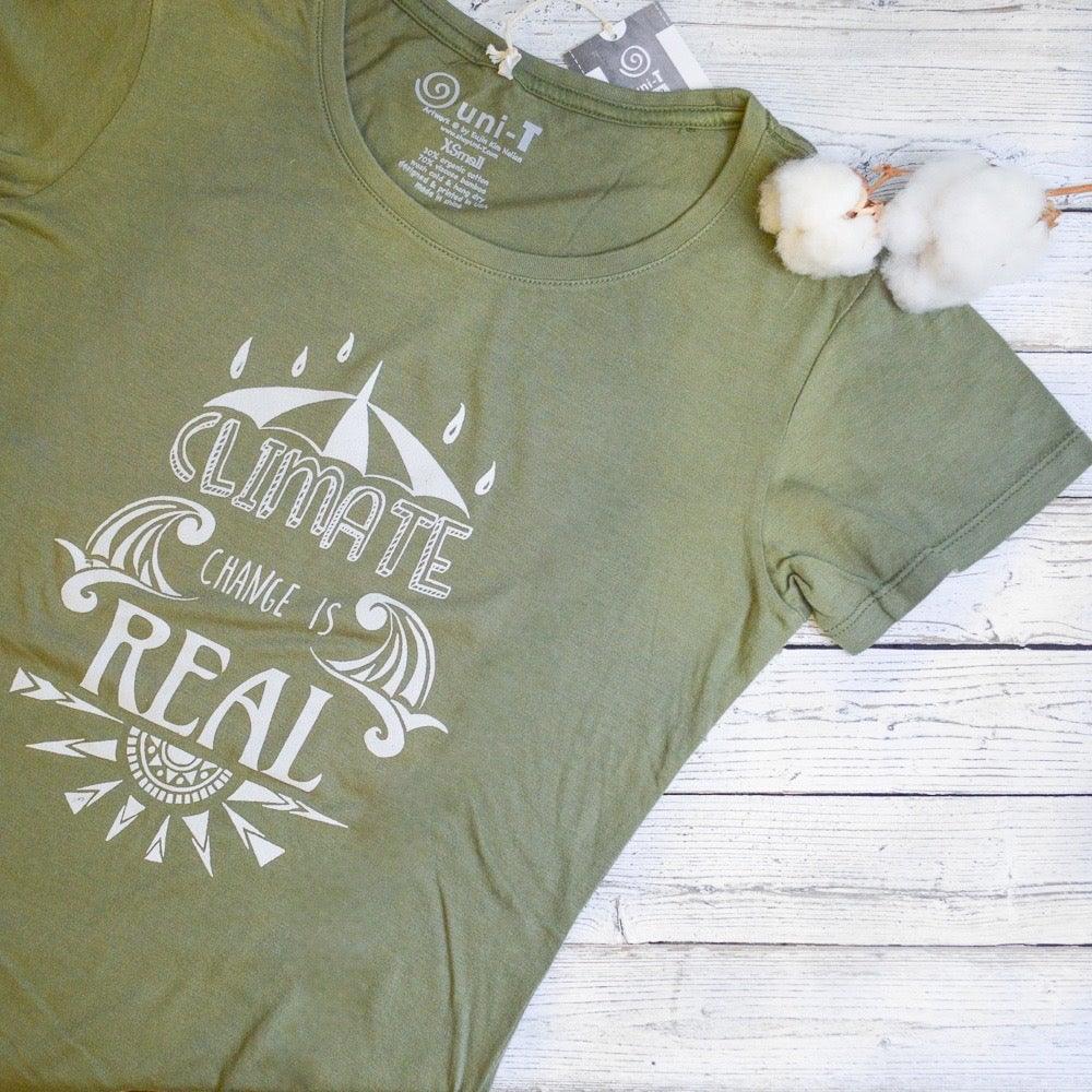 Close-up of olive green Women's Climate Change T-Shirt in bamboo & organic cotton, showing 'Climate Change is Real' print and soft fabric texture.