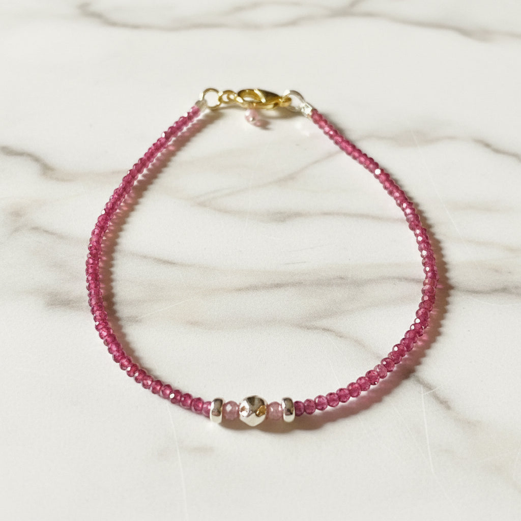 Dainty gemstone bracelet with faceted watermelon tourmaline beads and silver accents, featuring a secure clasp and minimalist design.