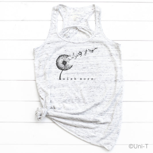 White marbled Wish More Flowy Tank Top tied at the hem, featuring a black dandelion and whimsical design. Lightweight and nature-inspired.