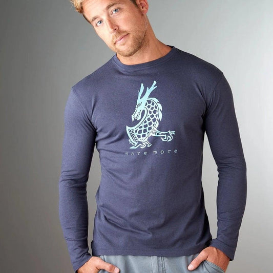 Model wearing navy blue bamboo and organic cotton long sleeve shirt with blue dragon print and 'dare more' slogan. Stylish eco-conscious apparel.