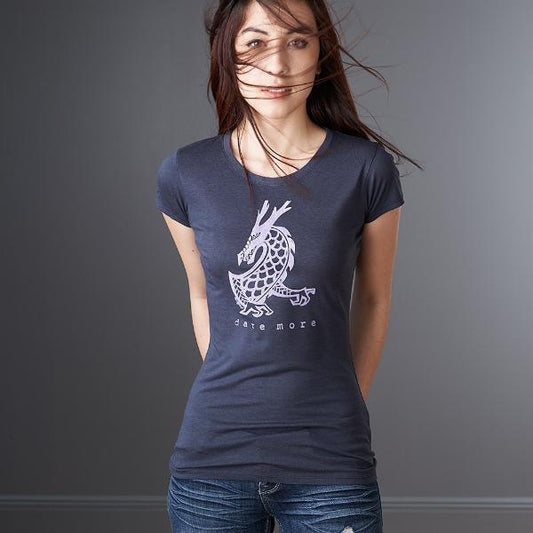 Woman wearing the 'Dare More' dragon T-shirt in navy blue, made from bamboo and organic cotton. Sustainable fantasy graphic tee for women by Uni-T.
