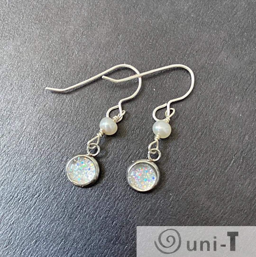 Sterling silver Glitter and Pearl Earrings - Pearl Earrings | Sterling Silver, Freshwater Pearls with shimmering glitter charms and pearls, laid flat on dark surface.