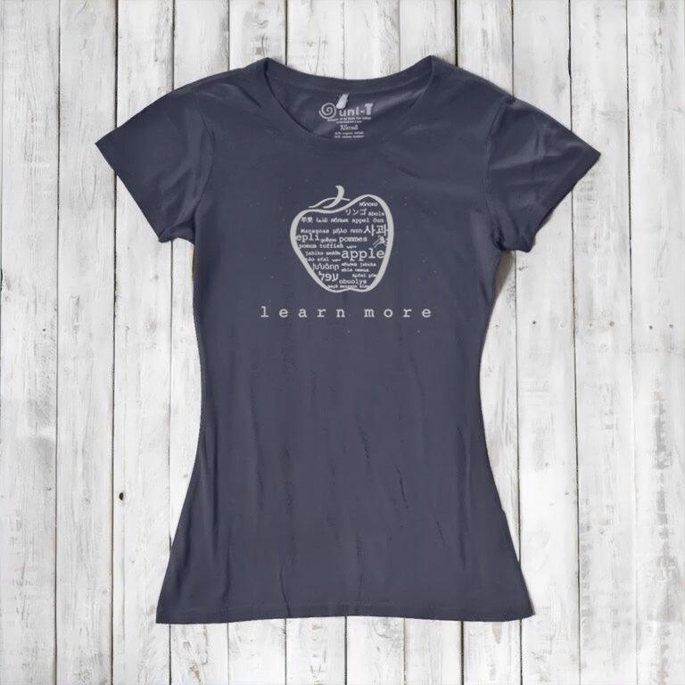 Navy blue women's apple T-shirt in bamboo & organic cotton with 'learn more' graphic, inspirational and sustainable teacher gift.