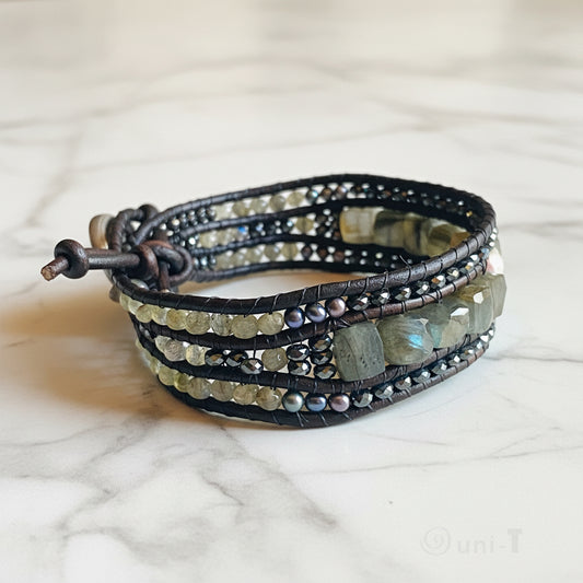 Multi gemstone cuff bracelet with leather wrap, showcasing labradorite, pearls, and faceted beads for a bold, elegant accessory.