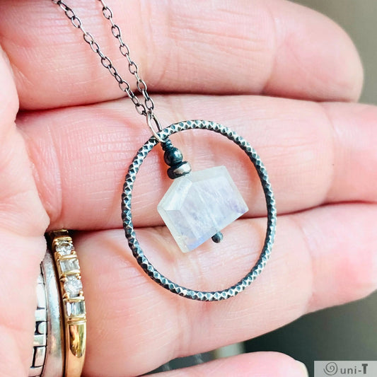 Close-up of Moonstone Infinity Necklace featuring hand-soldered silver circle and moonstone charm, ideal for fashion accessories.