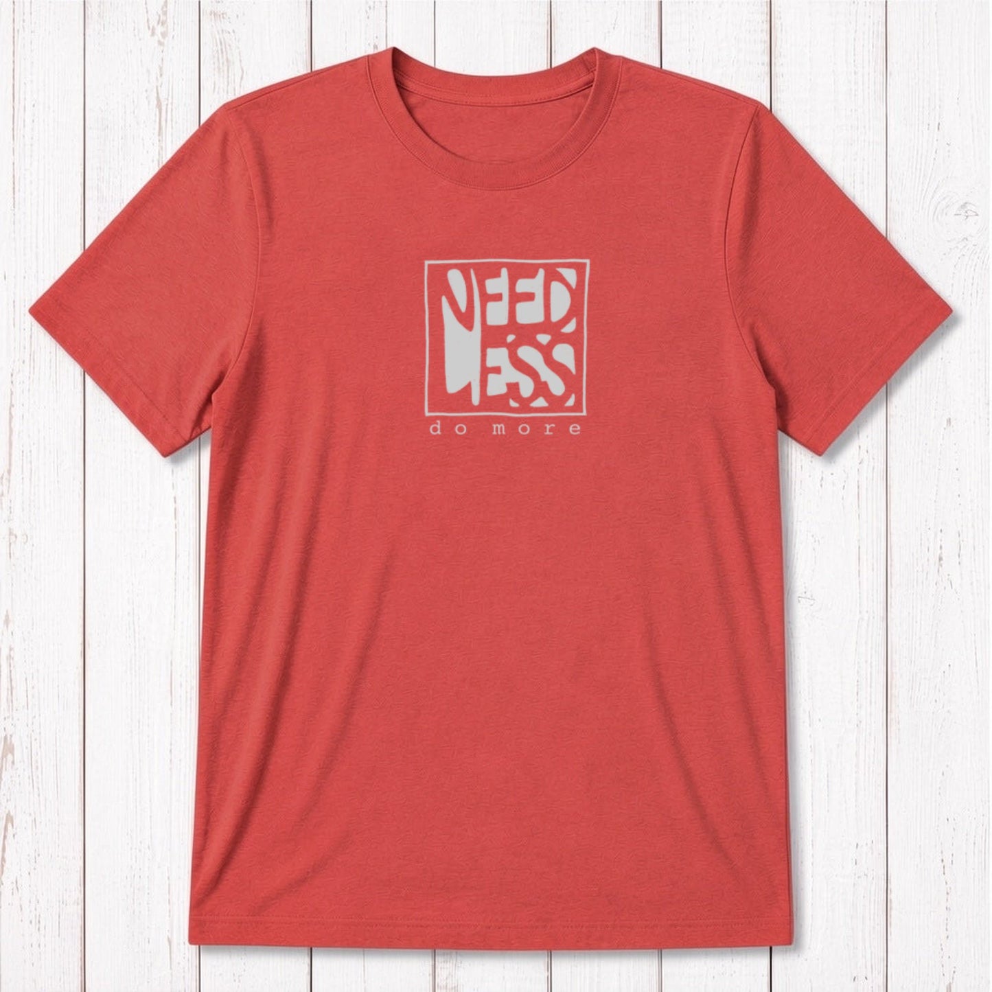 Coral red men's t-shirt in bamboo and organic cotton with 'Need Less Do More' quote. Sustainable classic fit tee for productivity enthusiasts.