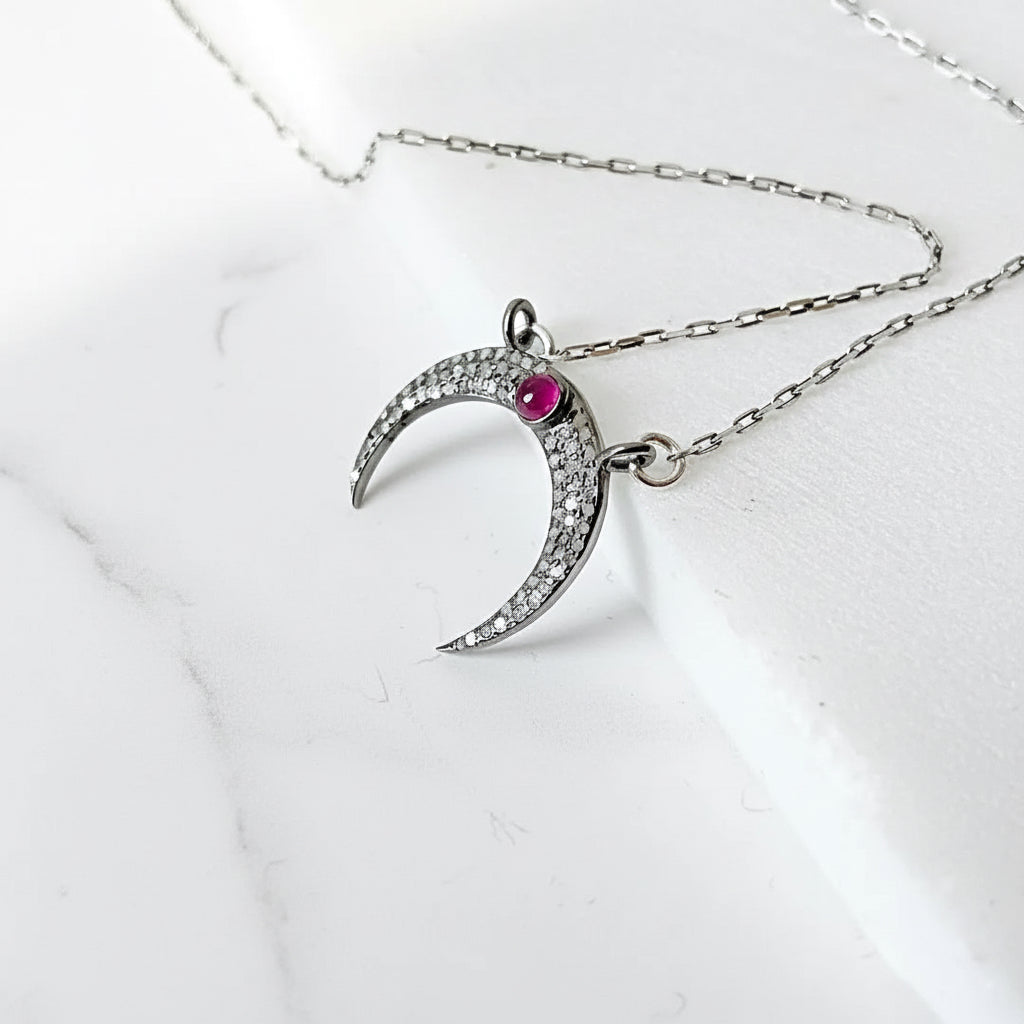 Sterling silver moonstone ruby necklace with crescent moon design, featuring pave set moonstone and ruby on a 16'' antique chain.