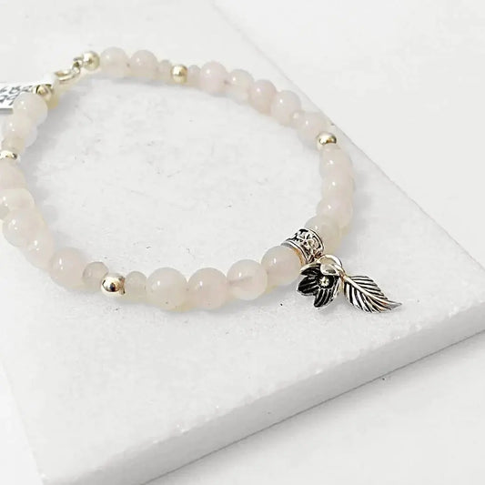 Sterling Silver Charms on Rose Quartz Silver Flower Bracelet featuring soft pink beads and detailed floral charm. Ideal for stylish gifting.