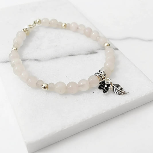 Sterling Silver Charms on Rose Quartz Silver Flower Bracelet featuring soft pink beads and detailed floral charm. Ideal for stylish gifting.